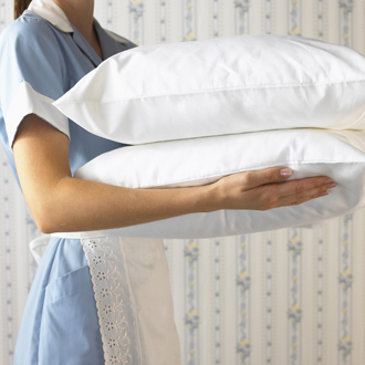 Side View of Maid Carrying Pillows