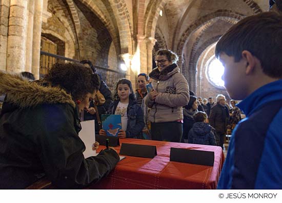 Yolanda de Gregorio en primer término, firmando ejemplares al término del acto